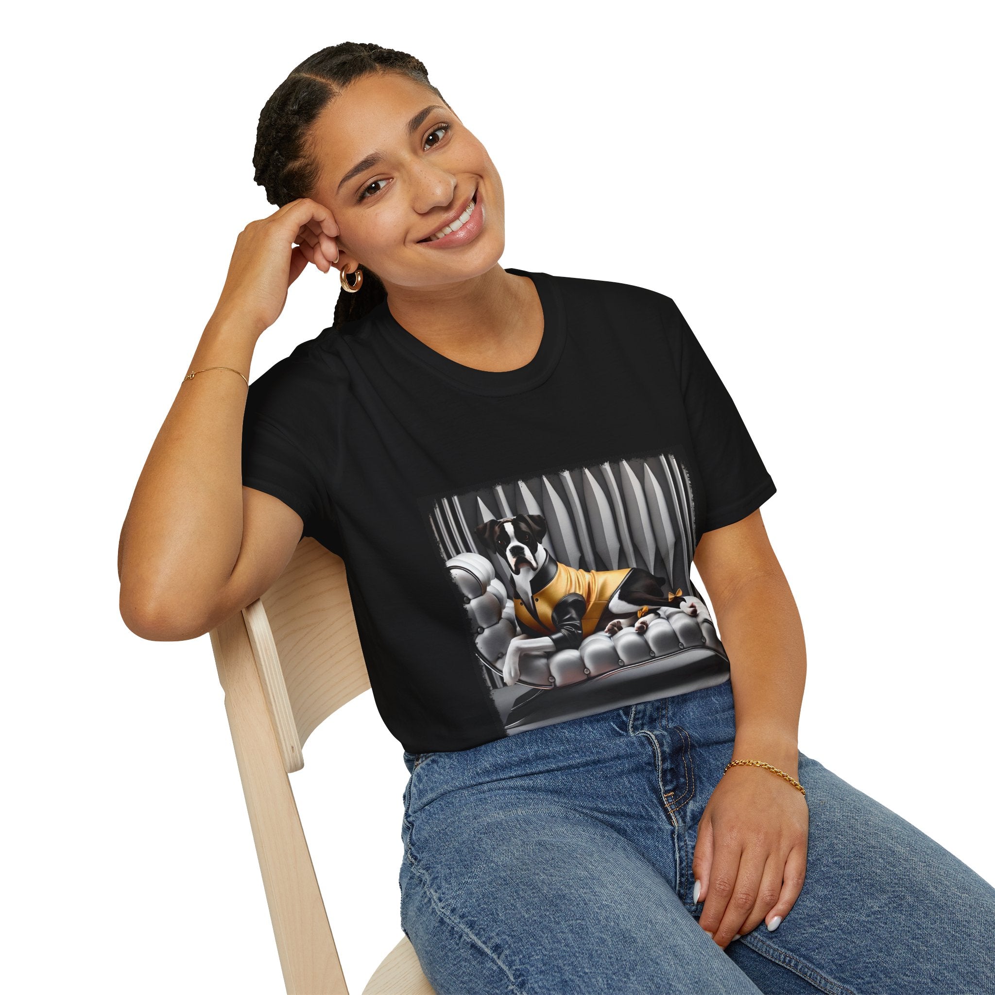 Female model in black dog t-shirt featuring a black and white boxer lounging on silver tufted couch in yellow jacket with striped wall.