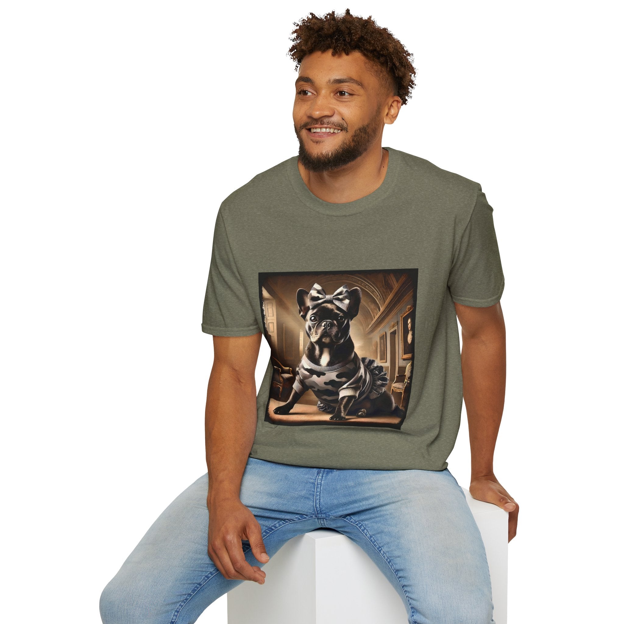 Male model in heather military green dog t-shirt featuring black French Bulldog in camo dress and bow, set in sepia-toned palace hall.
