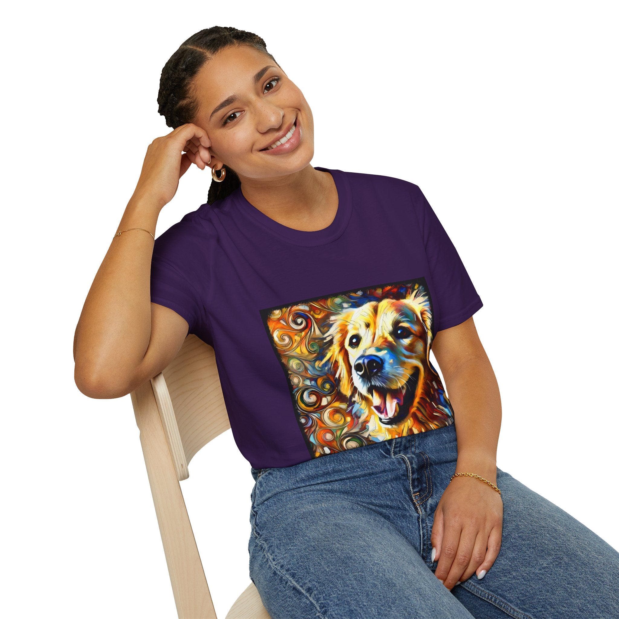 Female sitting in purple dog t-shirt featuring smiling golden retriever portrait with bold swirls in orange, gold, and blue.