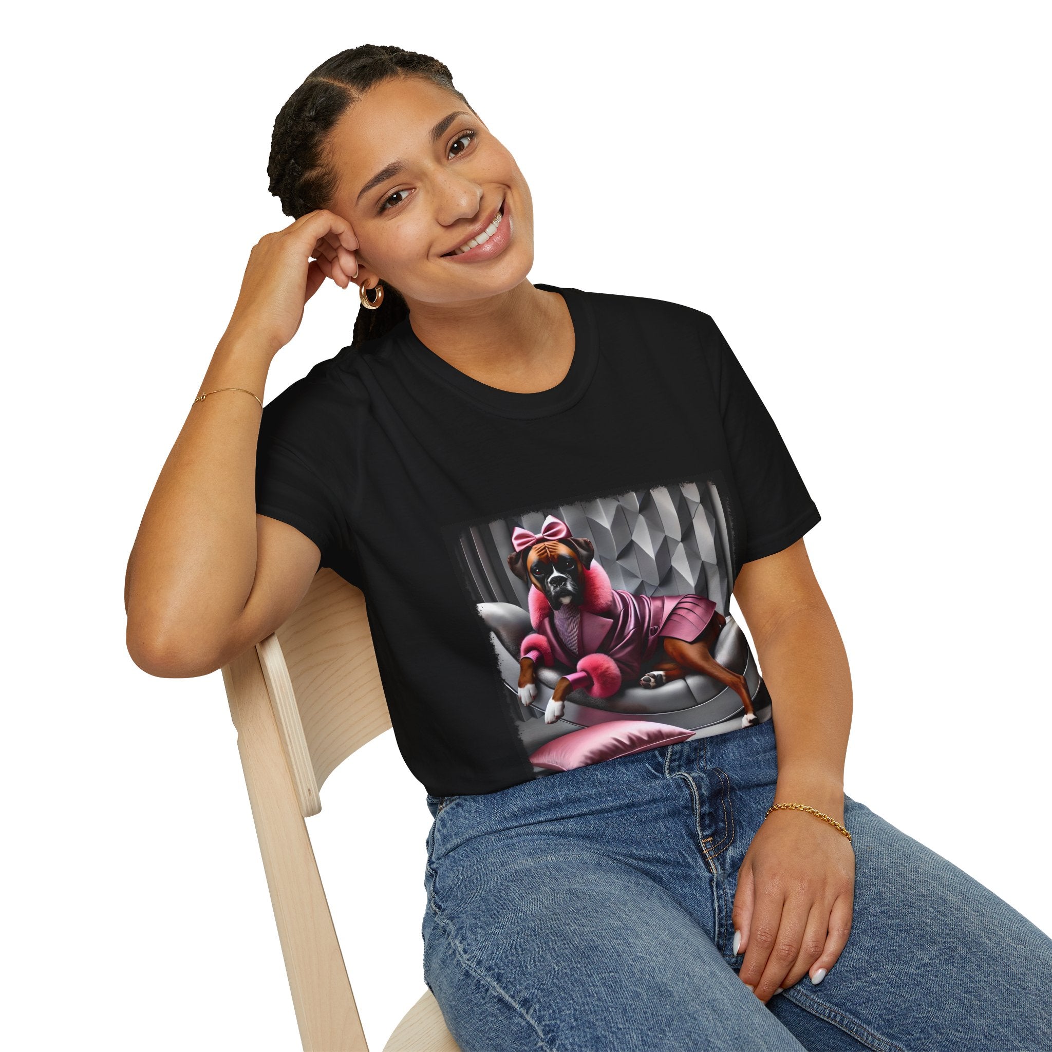 Female model in black dog t-shirt featuring boxer in pink bow and pleated pink coat lounging on silver settee.