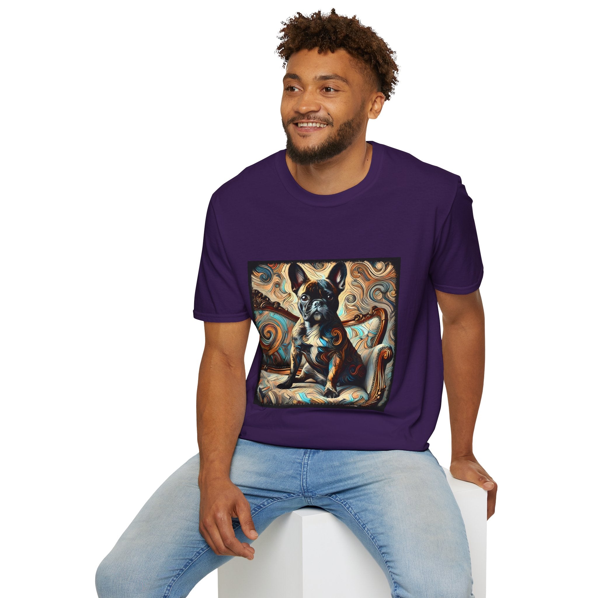 Male model wearing purple dog t-shirt featuring black and tan French Bulldog on ornate settee with swirl pattern background.
