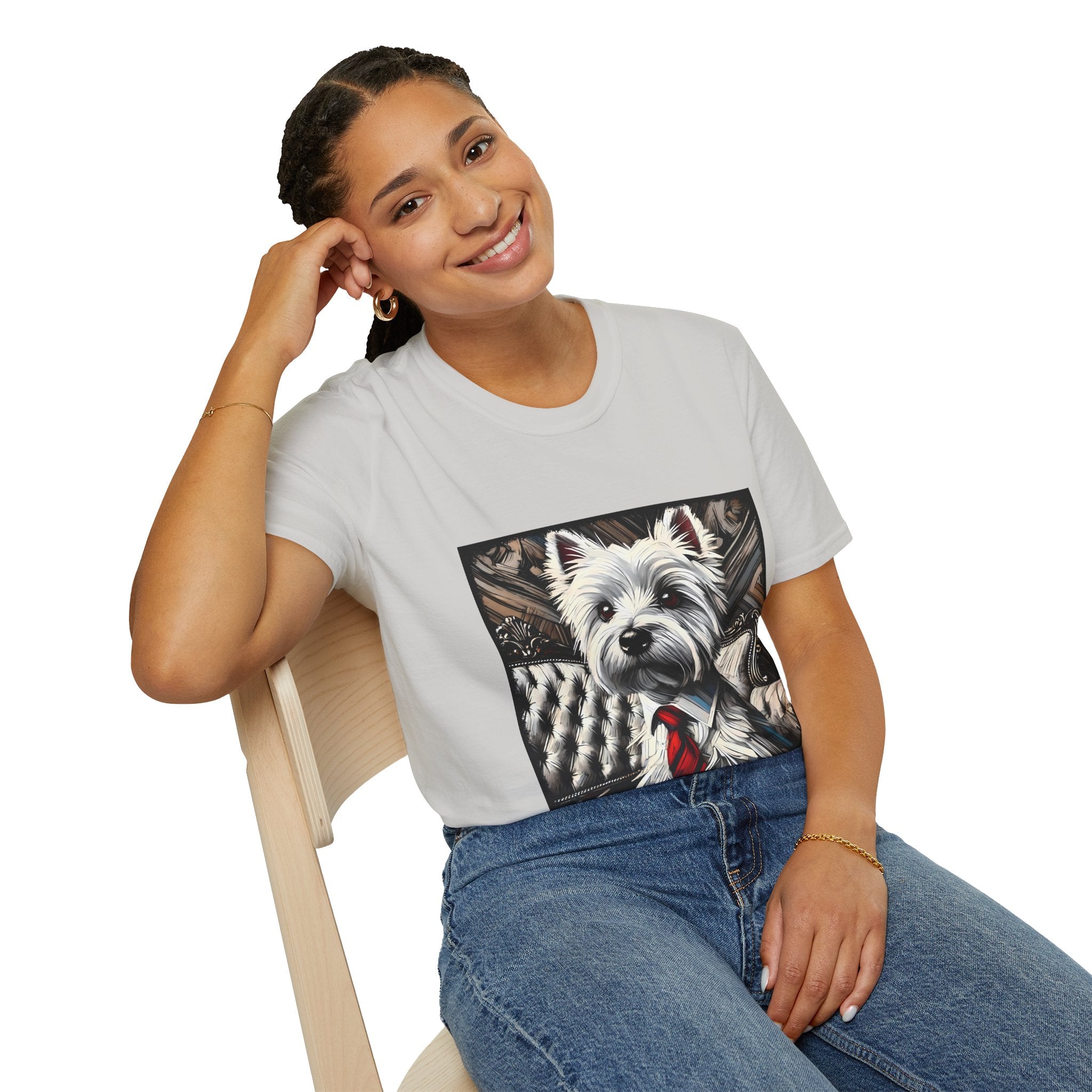 Female model in ice gray dog t-shirt featuring a Westie in a red tie seated on a tufted chair in a wood-accent room.
