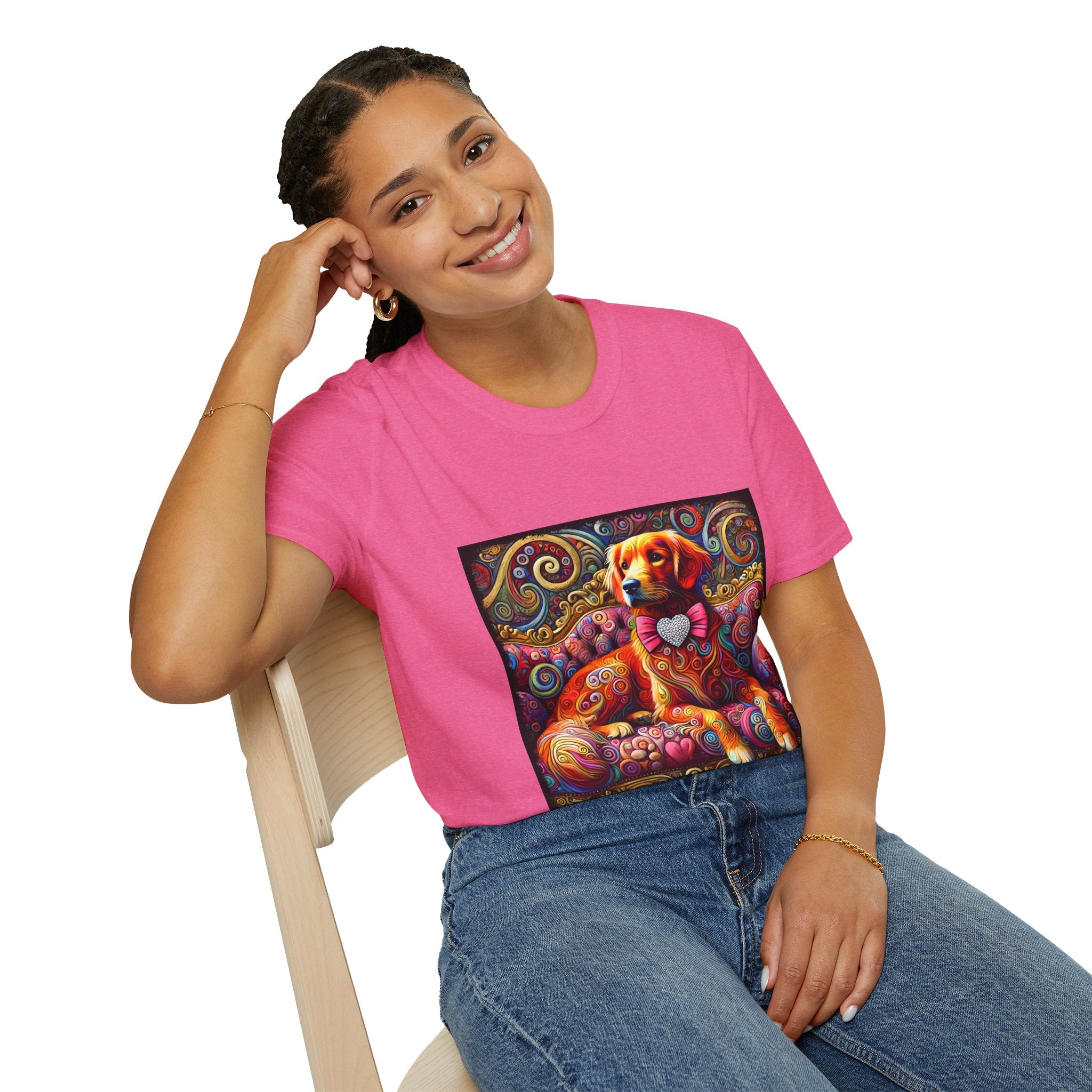 Woman sitting in bright pink dog t-shirt with golden retriever in pink bow on vibrant swirl settee with heart details.
